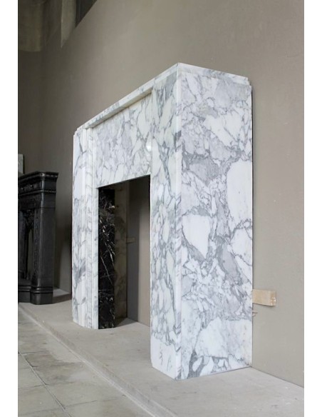 Antique iconic Art Deco mantelpiece carved in white veined Arabescato marble with Portoro marble inserts.