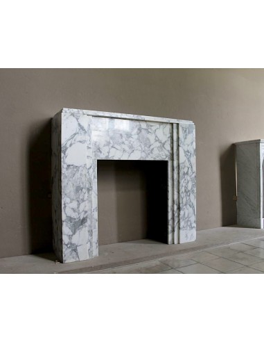 Antique iconic Art Deco mantelpiece carved in white veined Arabescato marble with Portoro marble inserts.