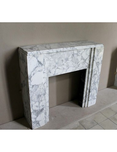 Antique iconic Art Deco mantelpiece carved in white veined Arabescato marble with Portoro marble inserts.