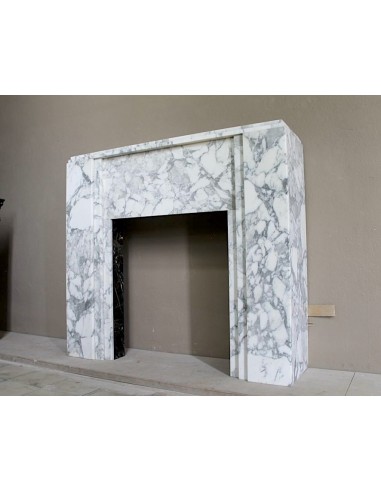 Antique iconic Art Deco mantelpiece carved in white veined Arabescato marble with Portoro marble inserts.