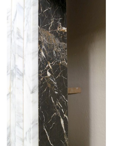 Antique iconic Art Deco mantelpiece carved in white veined Arabescato marble with Portoro marble inserts.