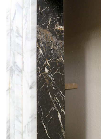 Antique iconic Art Deco mantelpiece carved in white veined Arabescato marble with Portoro marble inserts.