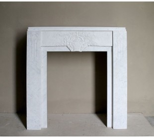 Antique genuine Art Deco mantelpiece, with iconic architecture and floral decorations, carved in white Carrara marble.