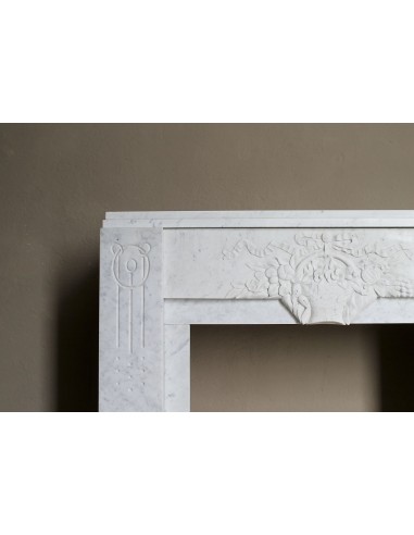 Antique genuine Art Deco mantelpiece, with iconic architecture and floral decorations, carved in white Carrara marble.
