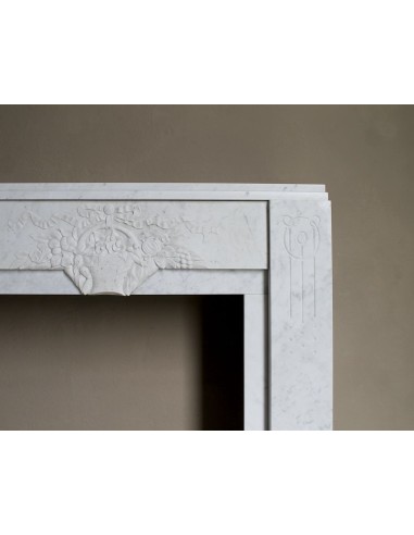 Antique genuine Art Deco mantelpiece, with iconic architecture and floral decorations, carved in white Carrara marble.