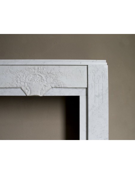 Antique genuine Art Deco mantelpiece, with iconic architecture and floral decorations, carved in white Carrara marble.