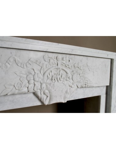 Antique genuine Art Deco mantelpiece, with iconic architecture and floral decorations, carved in white Carrara marble.