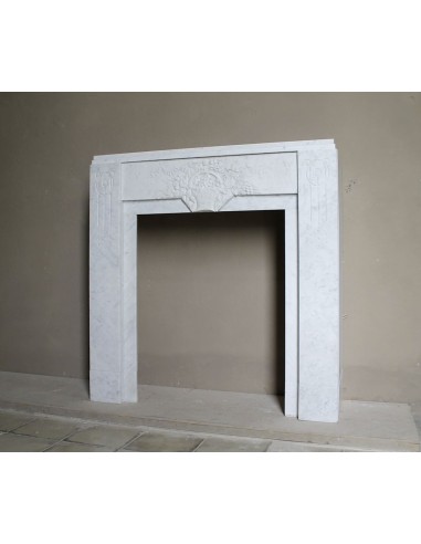 Antique genuine Art Deco mantelpiece, with iconic architecture and floral decorations, carved in white Carrara marble.