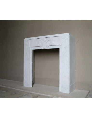 Antique genuine Art Deco mantelpiece, with iconic architecture and floral decorations, carved in white Carrara marble.