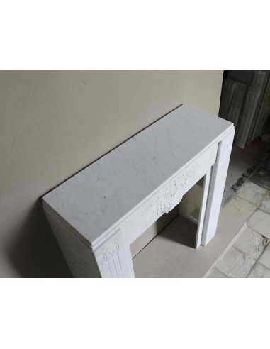 Antique genuine Art Deco mantelpiece, with iconic architecture and floral decorations, carved in white Carrara marble.