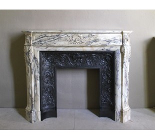 Neoclassical mantelpiece in veined Statuary marble with tones from white to beige to violet, with its original cast iron insert.