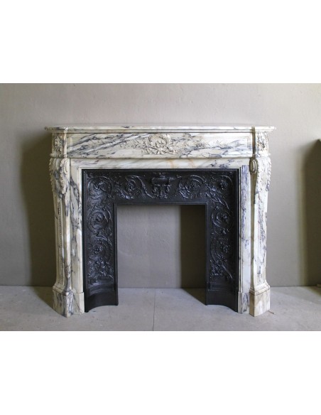 Neoclassical mantelpiece in veined Statuary marble with tones from white to beige to violet, with its original cast iron insert.
