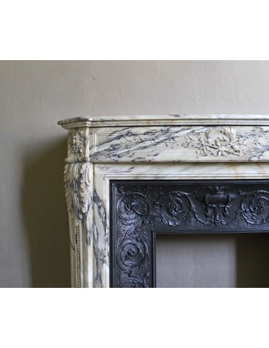 Neoclassical mantelpiece in veined Statuary marble with tones from white to beige to violet, with its original cast iron insert.
