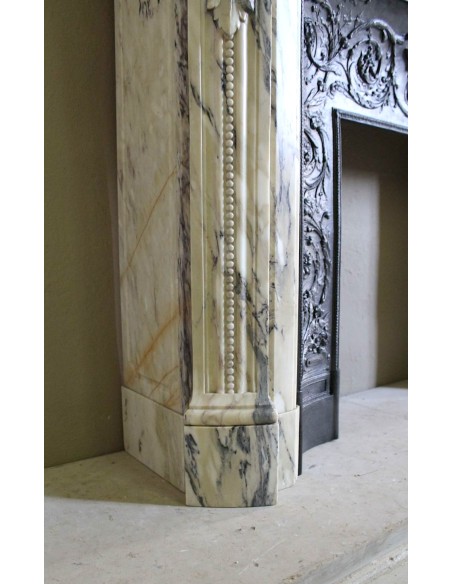 Neoclassical mantelpiece in veined Statuary marble with tones from white to beige to violet, with its original cast iron insert.