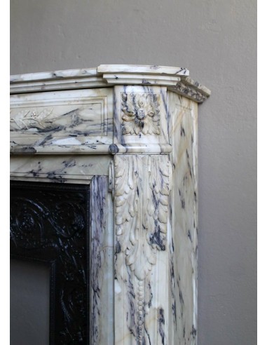 Neoclassical mantelpiece in veined Statuary marble with tones from white to beige to violet, with its original cast iron insert.