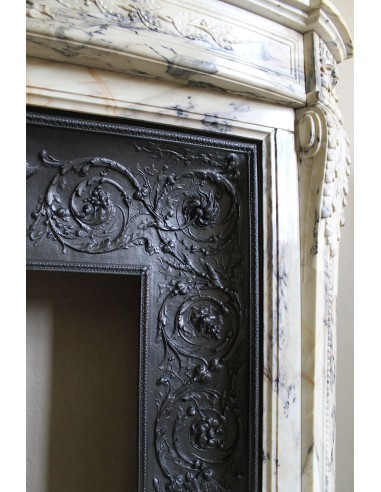 Neoclassical mantelpiece in veined Statuary marble with tones from white to beige to violet, with its original cast iron insert.