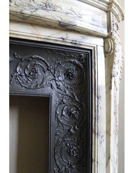 Neoclassical mantelpiece in veined Statuary marble with tones from white to beige to violet, with its original cast iron insert.