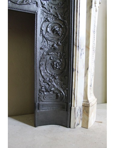 Neoclassical mantelpiece in veined Statuary marble with tones from white to beige to violet, with its original cast iron insert.
