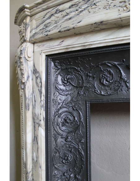 Neoclassical mantelpiece in veined Statuary marble with tones from white to beige to violet, with its original cast iron insert.