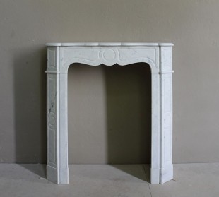 An antique Baroque “Pompadour Plat” fireplace mantel of small size, lovely and elegant, carved in white Carrara marble.