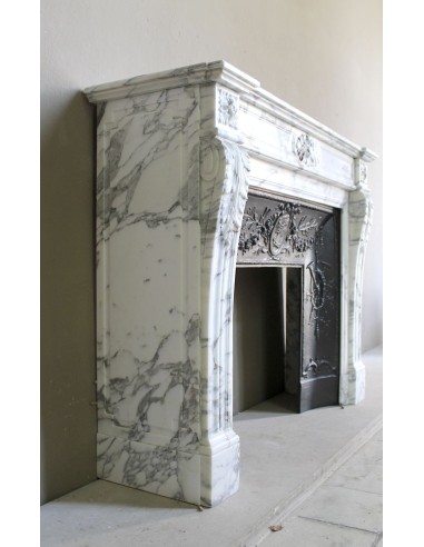 Neoclassical “Trois Fleurs” fireplace mantel in white veined marble, provided with its original cast iron insert.