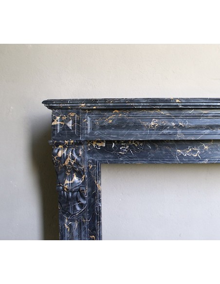 Genuine 19th century Portoro Gold marble fireplace mantel with diamond-pointed carvings.