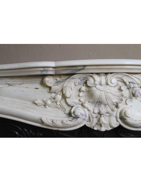 Antique Louis XV “Trois Glands” fireplace mantel in  White veined Calacatta marble provided with cast iron insert.