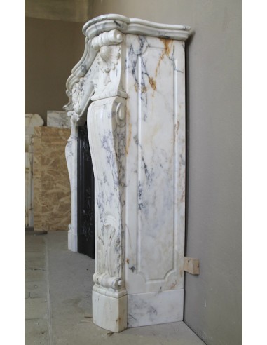 Antique Louis XV “Trois Glands” fireplace mantel in  White veined Calacatta marble provided with cast iron insert.