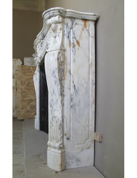 Antique Louis XV “Trois Glands” fireplace mantel in  White veined Calacatta marble provided with cast iron insert.