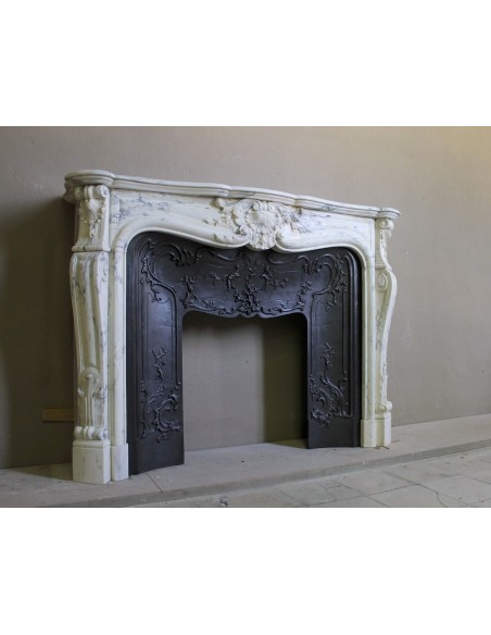 Antique Louis XV “Trois Glands” fireplace mantel in  White veined Calacatta marble provided with cast iron insert.