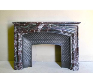 Antique “Boudin” mantelpiece in Levanto marble in red, green, violet, and white. This fireplace mantel has its cast iron insert.