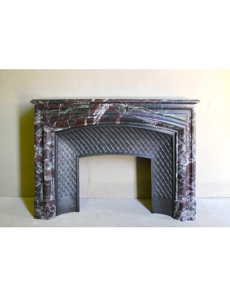 Antique “Boudin” mantelpiece in Levanto marble in red, green, violet, and white. This fireplace mantel has its cast iron insert.
