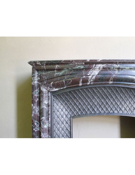 Antique “Boudin” mantelpiece in Levanto marble in red, green, violet, and white. This fireplace mantel has its cast iron insert.