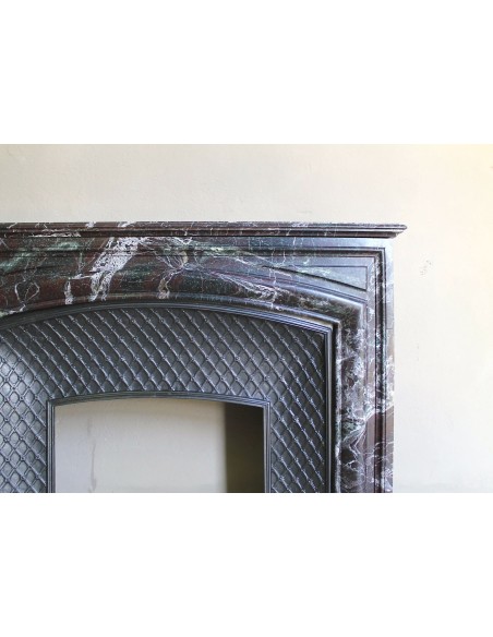 Antique “Boudin” mantelpiece in Levanto marble in red, green, violet, and white. This fireplace mantel has its cast iron insert.