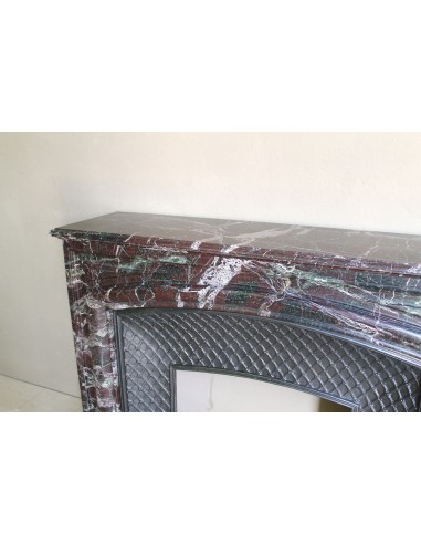 Antique “Boudin” mantelpiece in Levanto marble in red, green, violet, and white. This fireplace mantel has its cast iron insert.