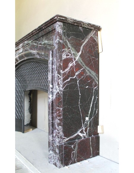 Antique “Boudin” mantelpiece in Levanto marble in red, green, violet, and white. This fireplace mantel has its cast iron insert.