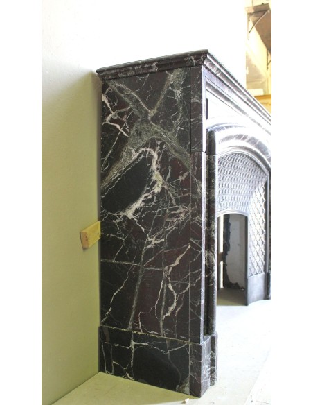 Antique “Boudin” mantelpiece in Levanto marble in red, green, violet, and white. This fireplace mantel has its cast iron insert.