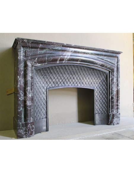 Antique “Boudin” mantelpiece in Levanto marble in red, green, violet, and white. This fireplace mantel has its cast iron insert.