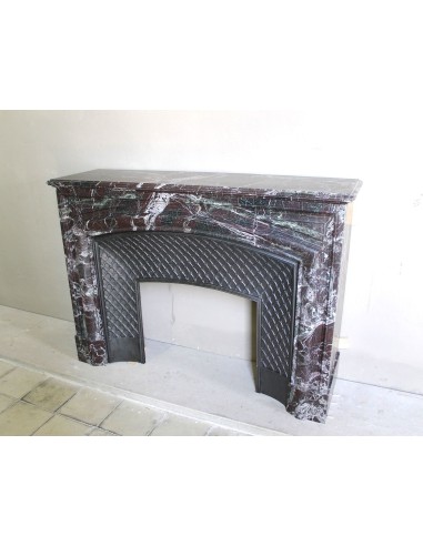 Antique “Boudin” mantelpiece in Levanto marble in red, green, violet, and white. This fireplace mantel has its cast iron insert.
