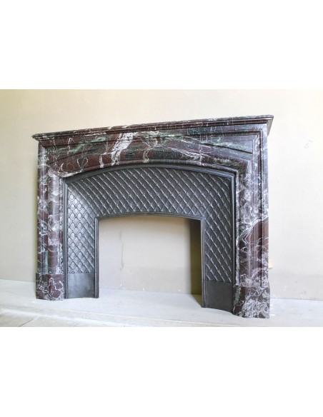 Antique “Boudin” mantelpiece in Levanto marble in red, green, violet, and white. This fireplace mantel has its cast iron insert.