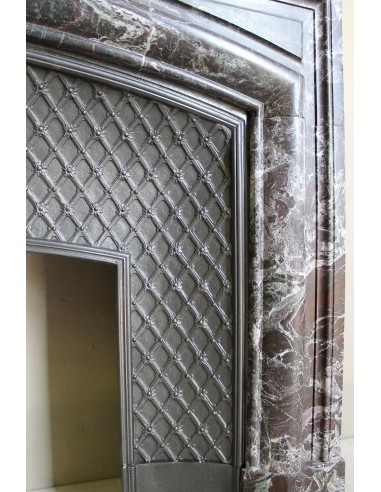 Antique “Boudin” mantelpiece in Levanto marble in red, green, violet, and white. This fireplace mantel has its cast iron insert.