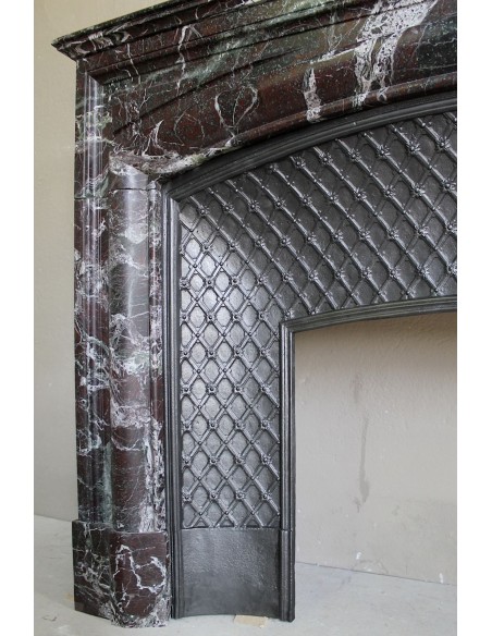 Antique “Boudin” mantelpiece in Levanto marble in red, green, violet, and white. This fireplace mantel has its cast iron insert.