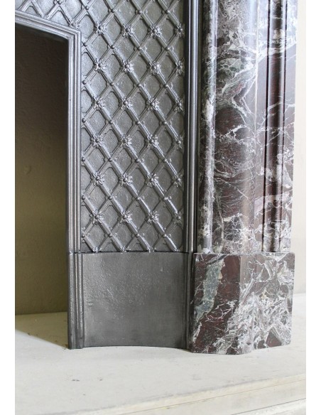 Antique “Boudin” mantelpiece in Levanto marble in red, green, violet, and white. This fireplace mantel has its cast iron insert.