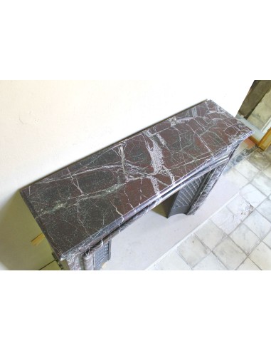 Antique “Boudin” mantelpiece in Levanto marble in red, green, violet, and white. This fireplace mantel has its cast iron insert.