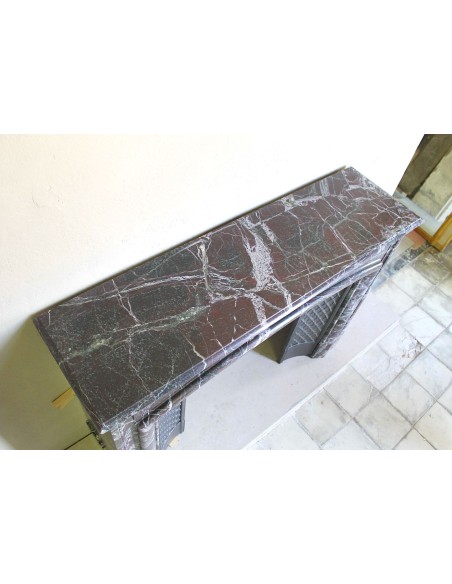 Antique “Boudin” mantelpiece in Levanto marble in red, green, violet, and white. This fireplace mantel has its cast iron insert.