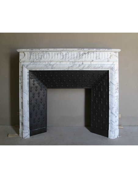 Antique “Boudin” fireplace mantel carved in veined white Calacatta marble. This mantel has its original cast iron insert.