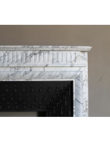 Antique “Boudin” fireplace mantel carved in veined white Calacatta marble. This mantel has its original cast iron insert.