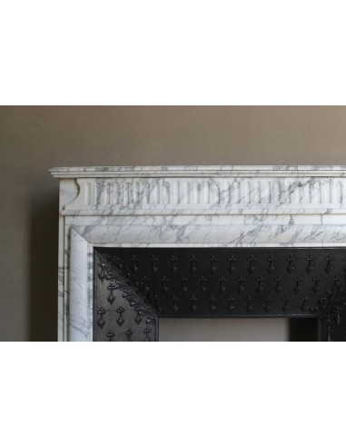 Antique “Boudin” fireplace mantel carved in veined white Calacatta marble. This mantel has its original cast iron insert.