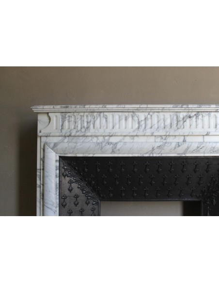 Antique “Boudin” fireplace mantel carved in veined white Calacatta marble. This mantel has its original cast iron insert.