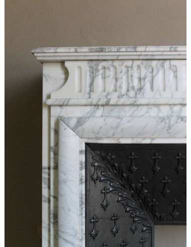 Antique “Boudin” fireplace mantel carved in veined white Calacatta marble. This mantel has its original cast iron insert.